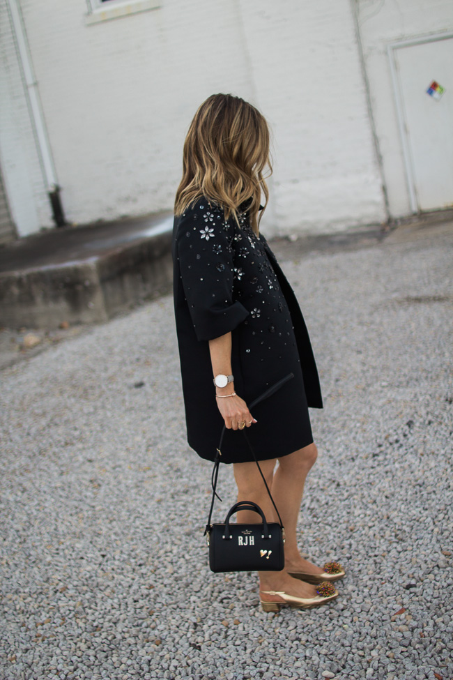 At a dinner wearing a black blazer dress with a Kate Spade bag