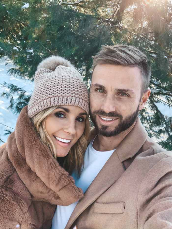 girl in warm, winter but stylish clothes defiantly looks at camera of  phone, poses for good selfie Stock Photo by look_studio